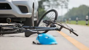 Black Bicycle and Blue Helmet on the Road After an Accident