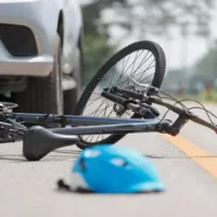 Black Bicycle and Blue Helmet on the Road After an Accident