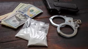 Cocaine Plastic Packets, Pistol Us Dollars Banknotes, and Handcuffs