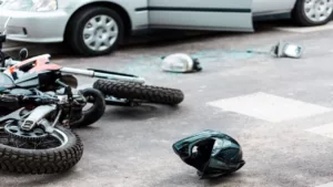 Overturned Motorcycle and Helmet on the Street After Collision with the Car