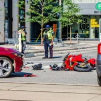 Motorcycle Was Hit by a Car on the Street During a Summer Day