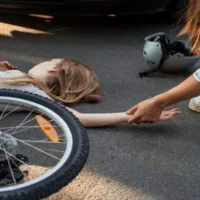 Girl Lying on the Street After Getting Hit While Riding Her Bicycle