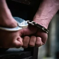A Man with Handcuffs Arrested for His Crime