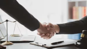 A Lawyer and His Client Hand Shaking After a Meeting Inside His Office