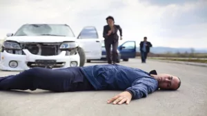 A Man Was Injured in a Car Accident and Motionlessly Lying Down on the Road