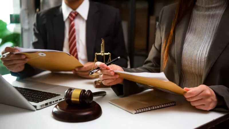 Lawyers discussing about a contract at a desk